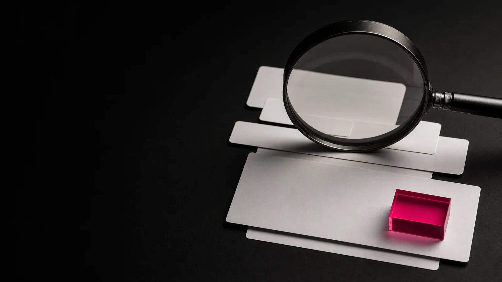 A magnifying glass over editorial cards